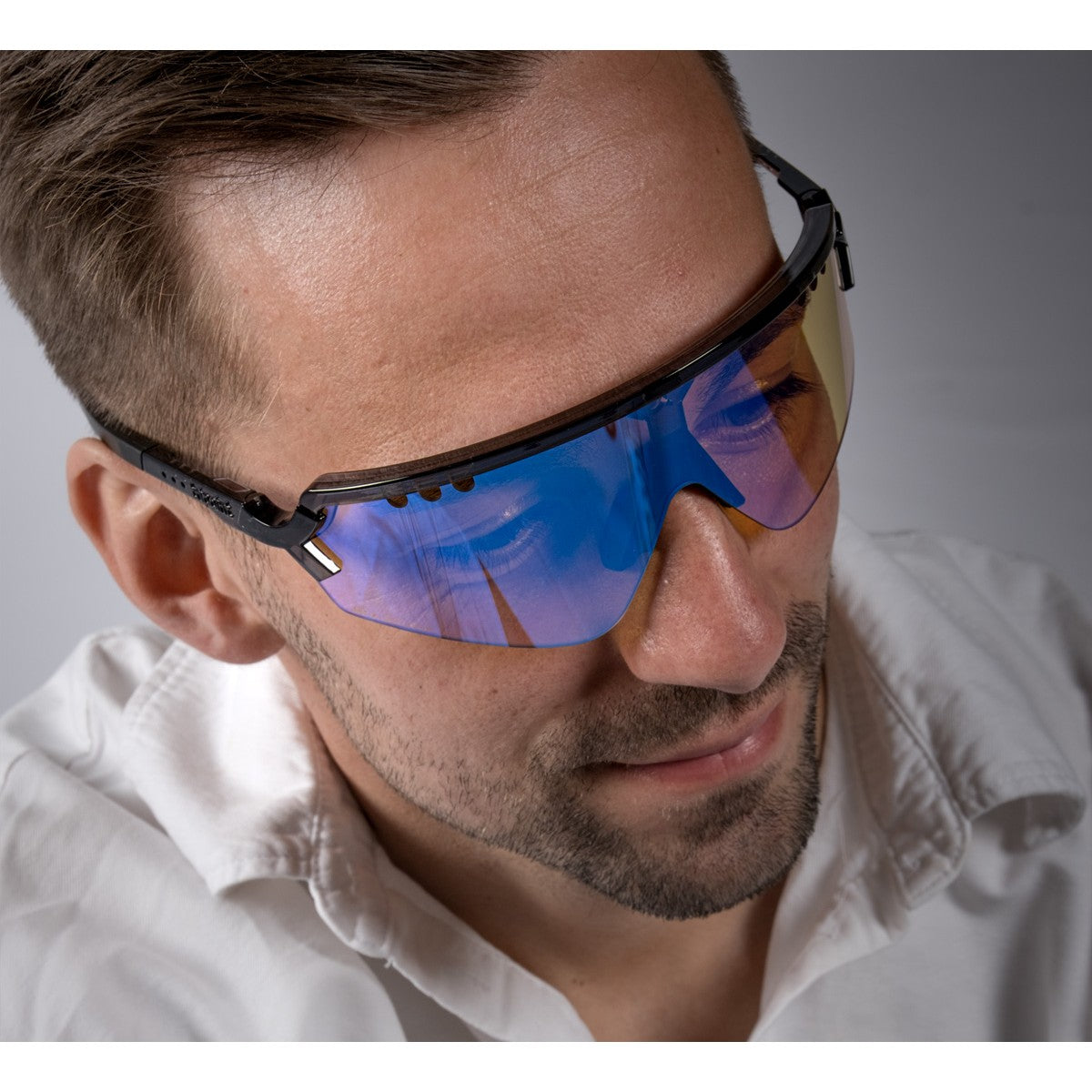 On-model view of tripoint 007 chobe UltraVue sunglasses, clear black frame, orange blue lens